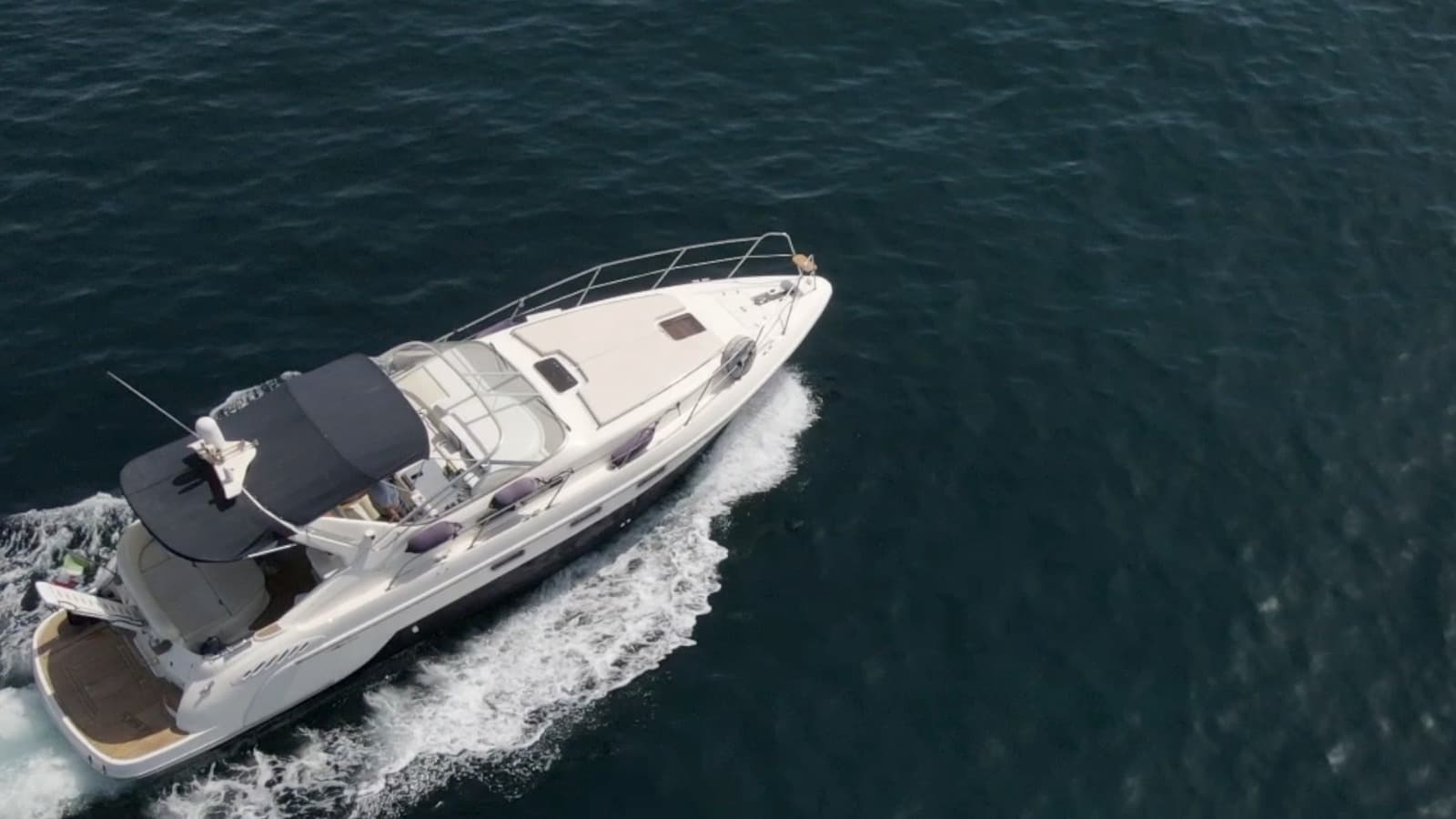 Luxury motorboat cruising fast over deep ocean waters