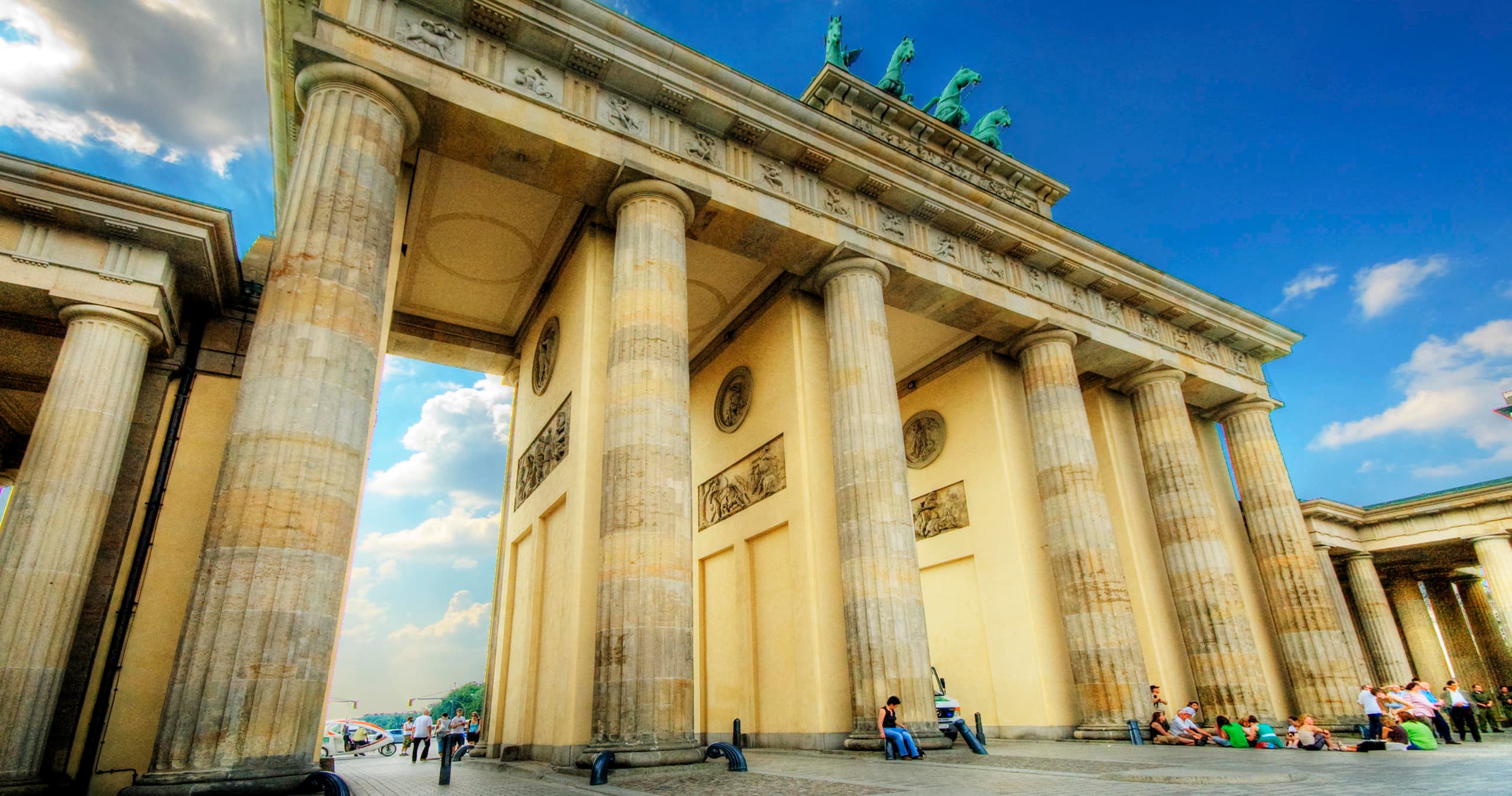 Cyclists touring at Brandenburg Gate, Berlin iconic outdoor landmark