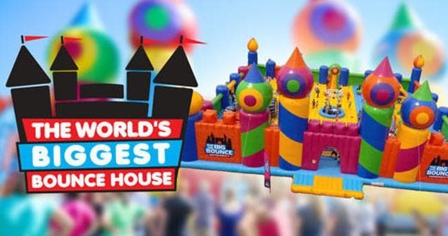 Colorful giant bounce house attraction banner at event