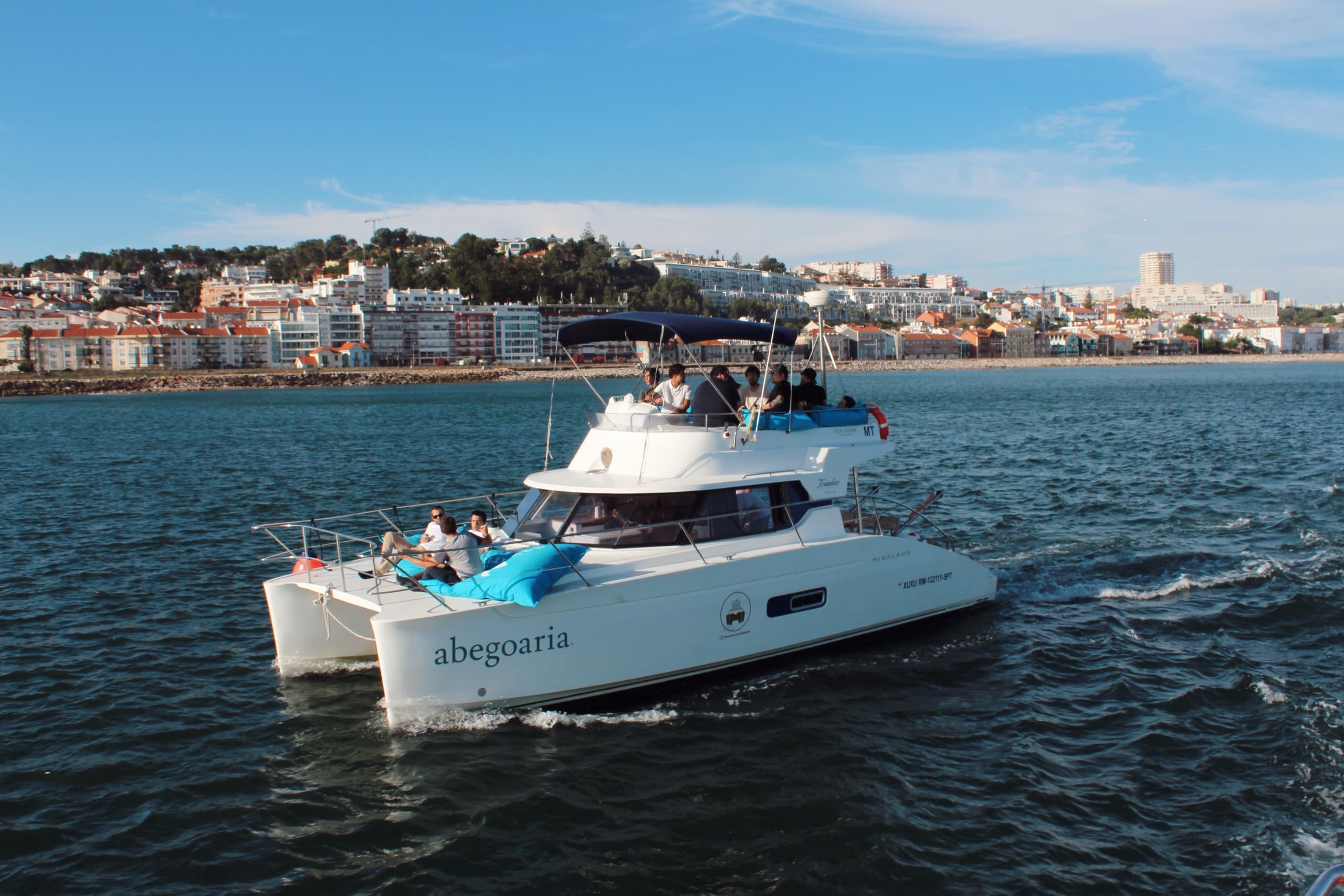 Motorboat cruising Lisbon Bay past waterfront city skyline