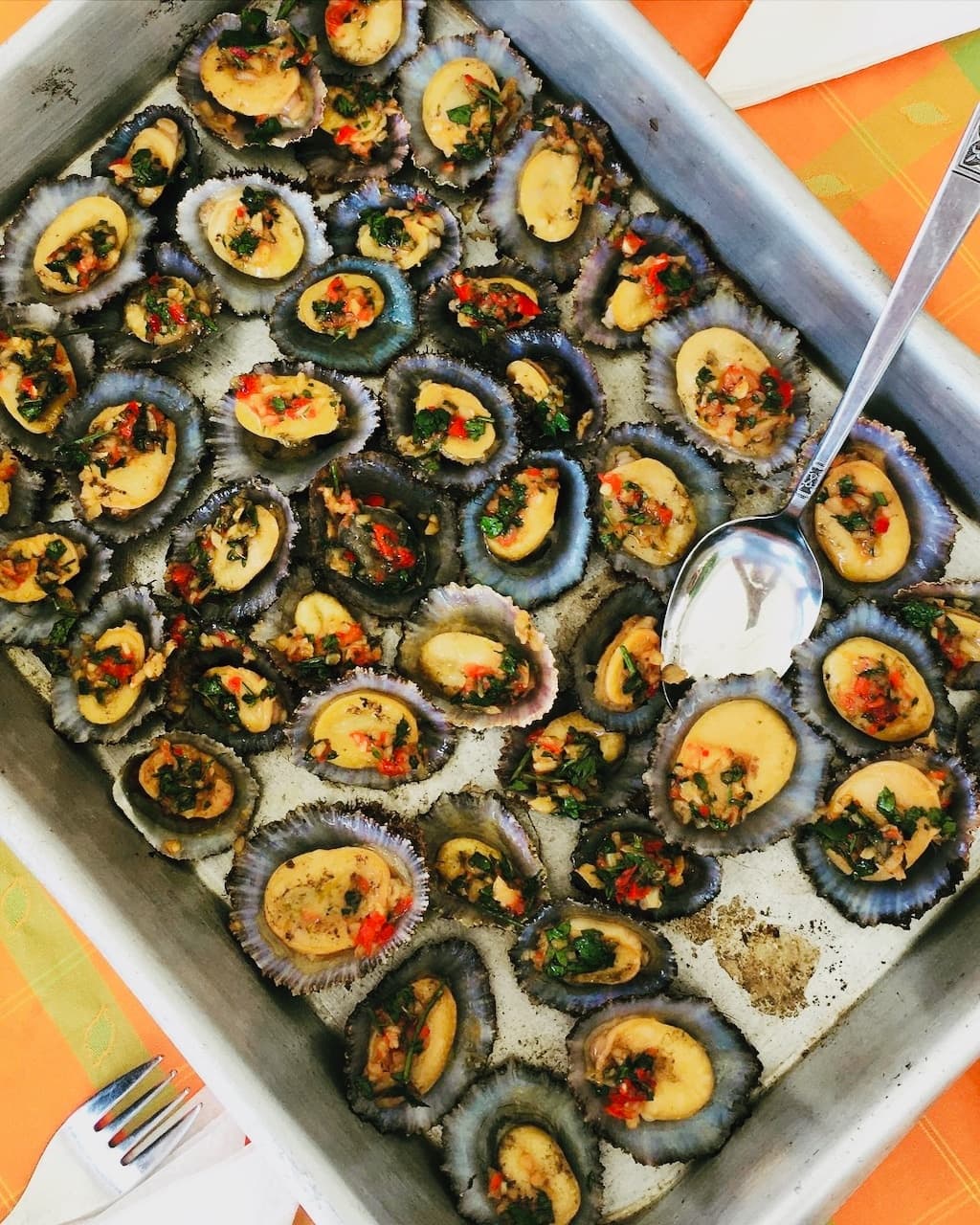 Baked sea urchin appetizers on tray for coastal seafood tasting