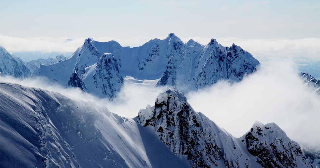 Snow-covered mountain peaks, alpine skiing terrain