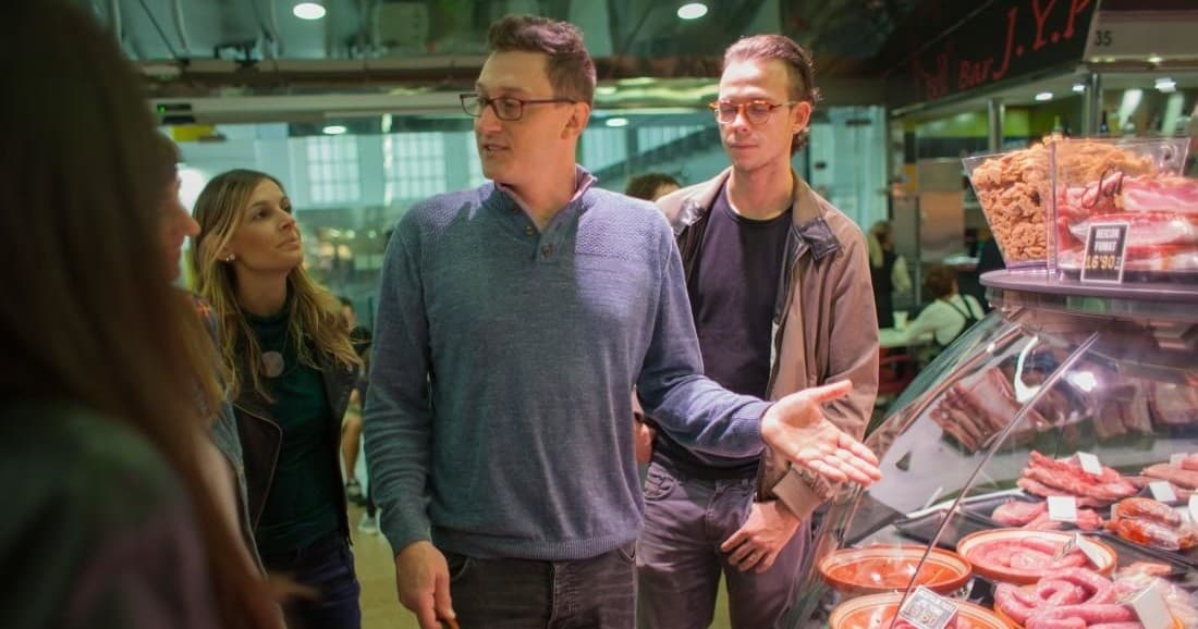 Tourists browsing fresh seafood stalls at Barcelona market tour