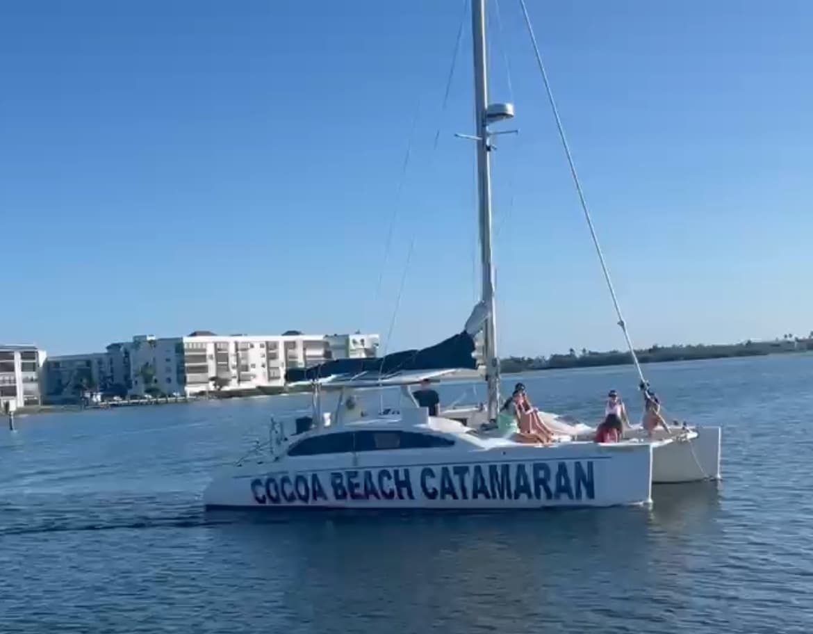 Cocoa Beach catamaran tour gliding on calm harbor waters under sun