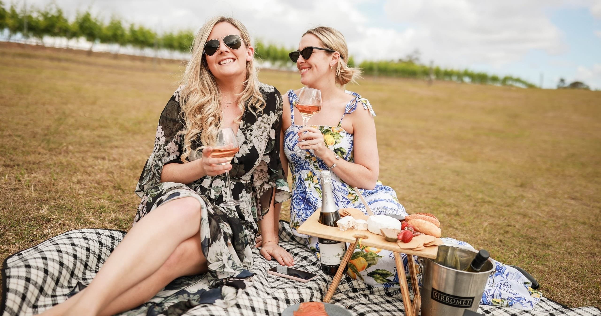 Picnic on vineyard lawn at Sirromet with friends enjoying wine