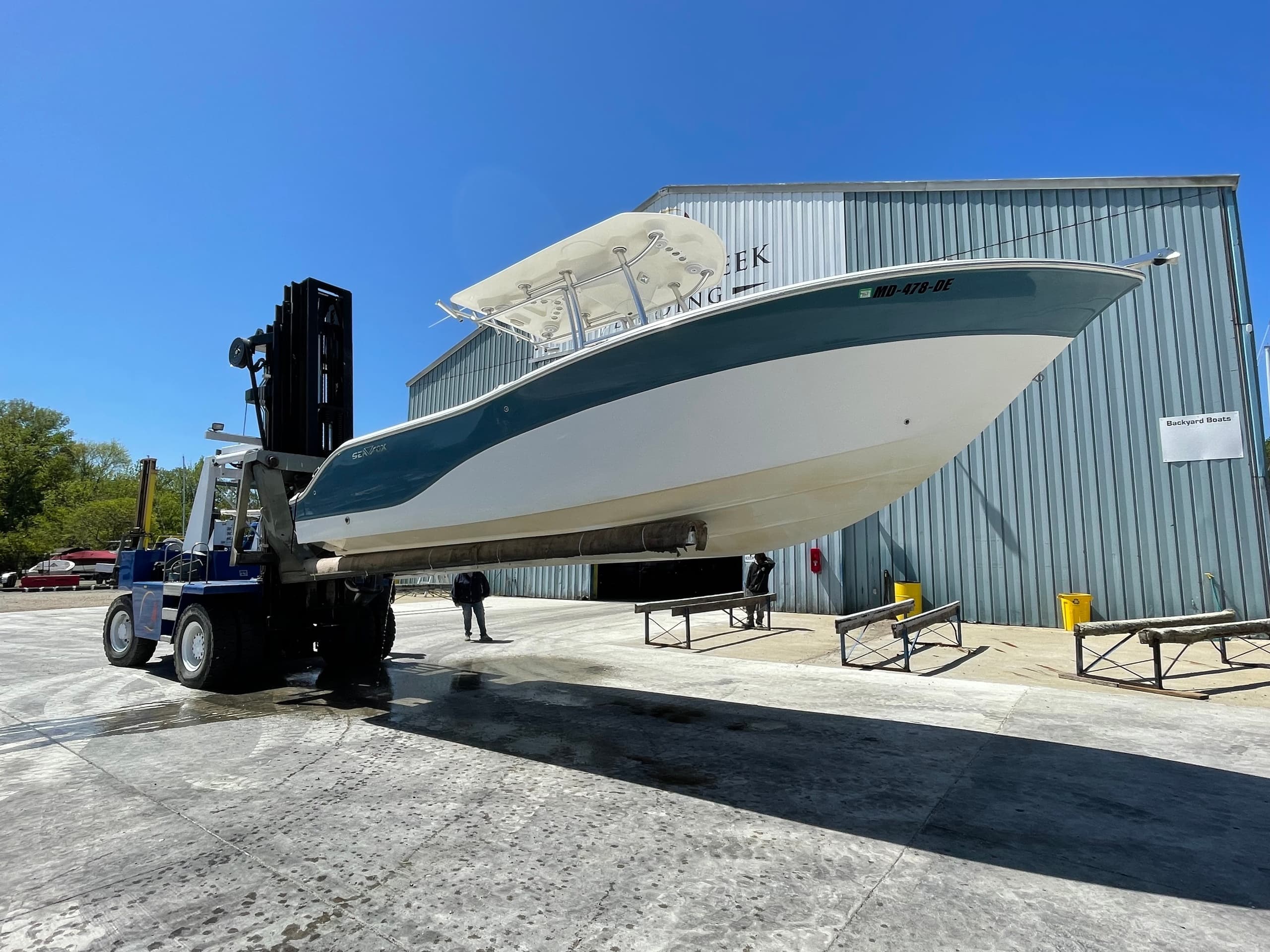 Powerboat at marina being lifted for Chesapeake coastal cruise