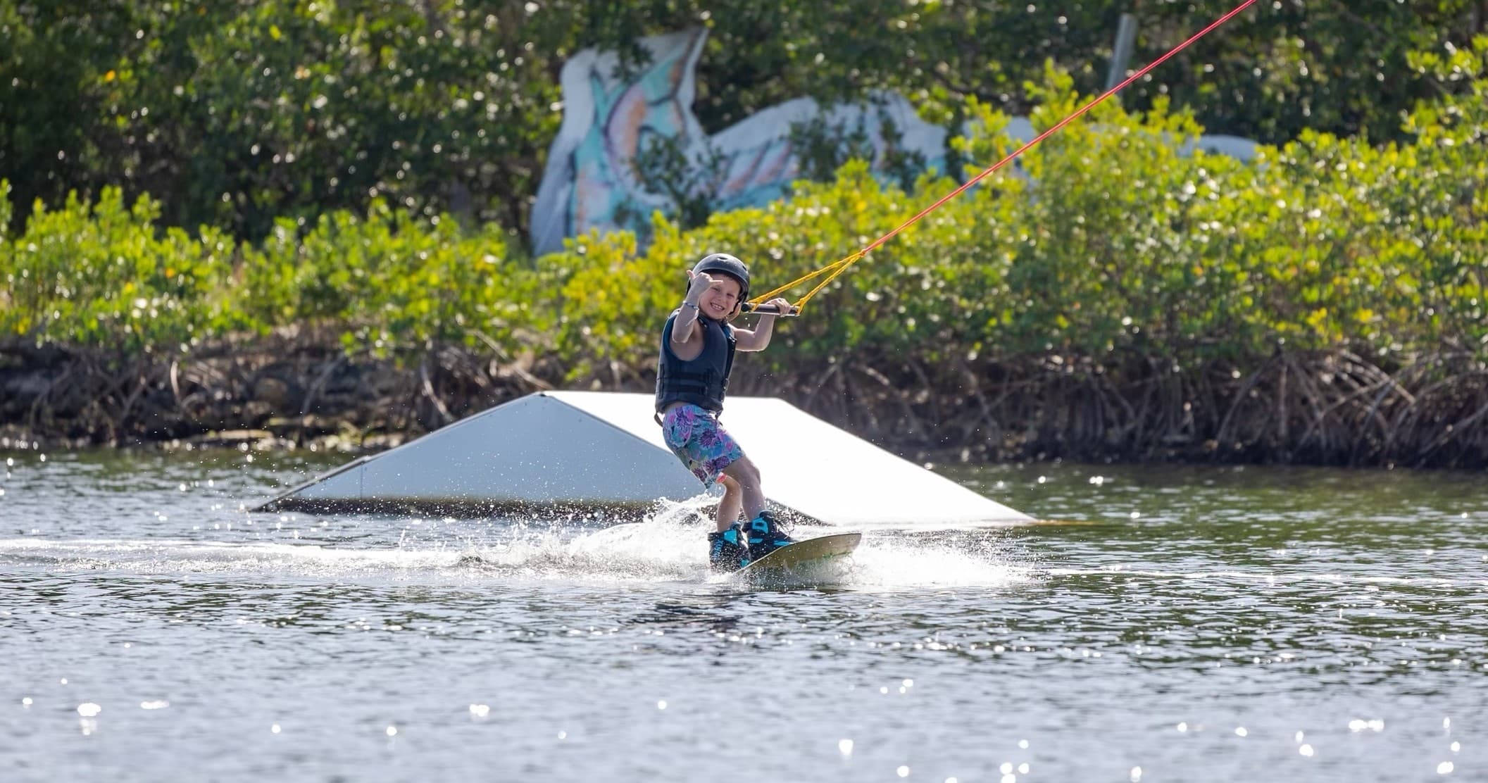Wakeboarder near mangroves enjoying shallow lagoon waters