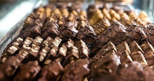 Assorted gourmet chocolate truffles in shop display case