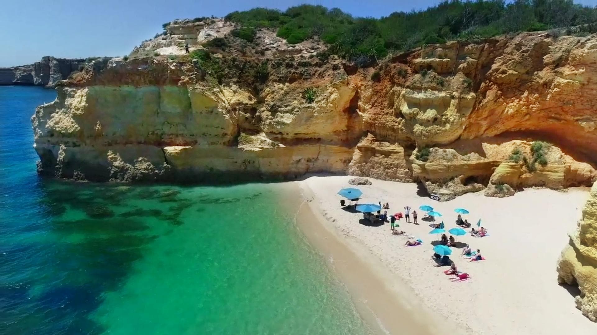 Aerial view of Algarve turquoise bay with sandy beach