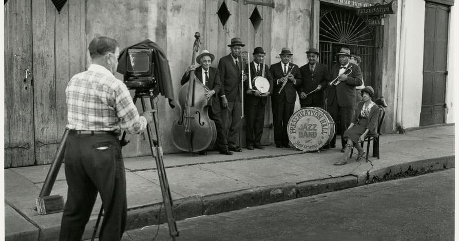 Filmmaker shooting street jazz band performance in New Orleans