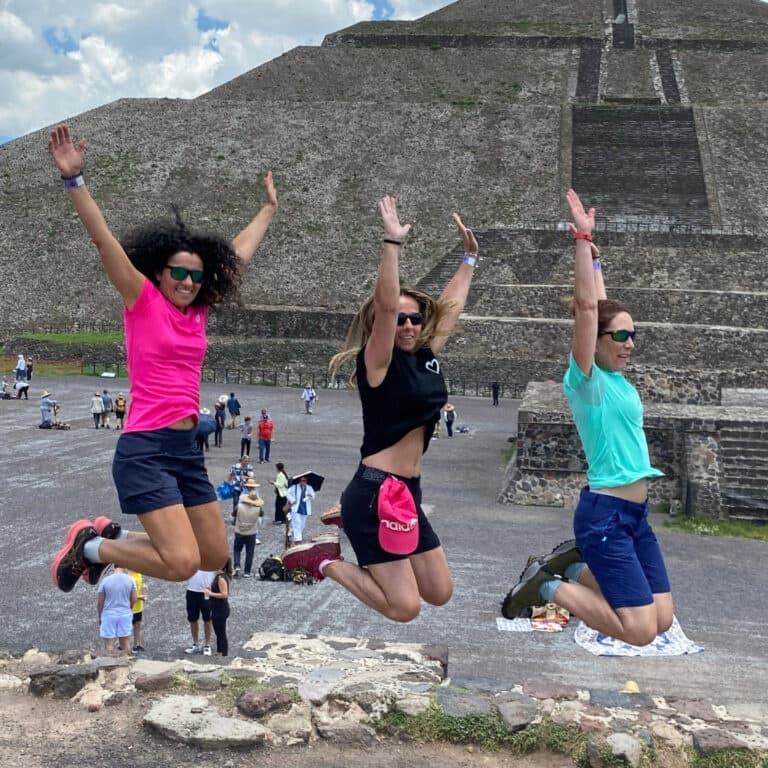 Jumping tourists at Teotihuacan pyramids during outdoor hike
