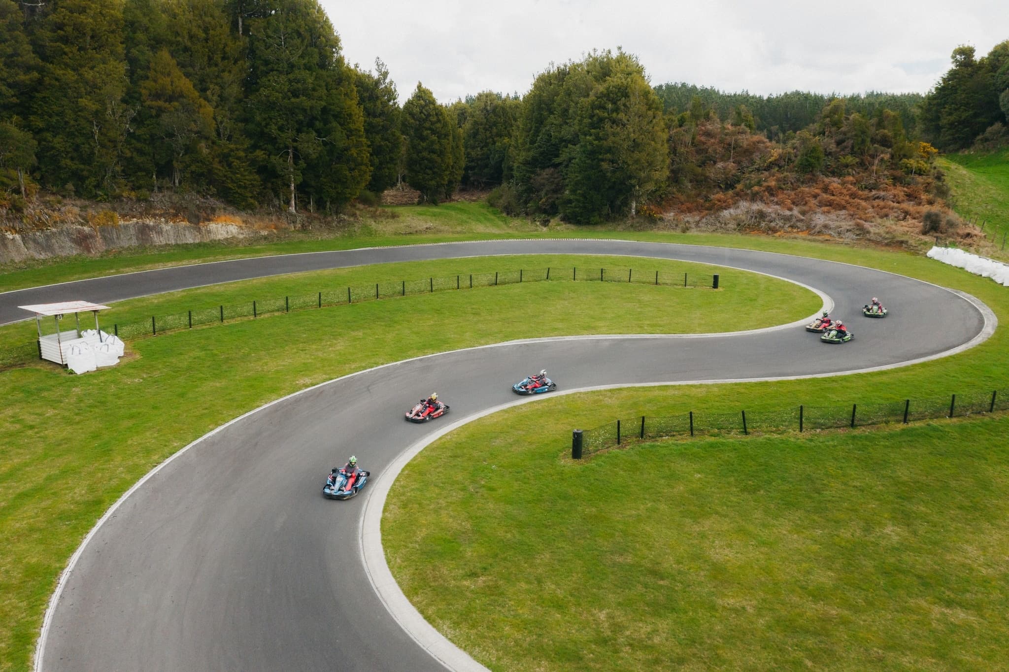 Aerial view of go-karts racing a winding outdoor track