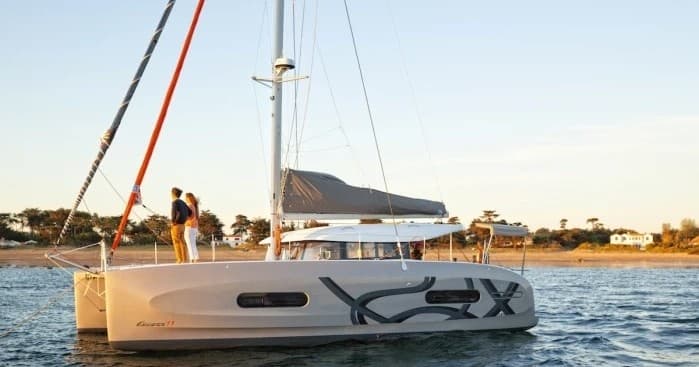 Catamaran anchored near shore at golden hour