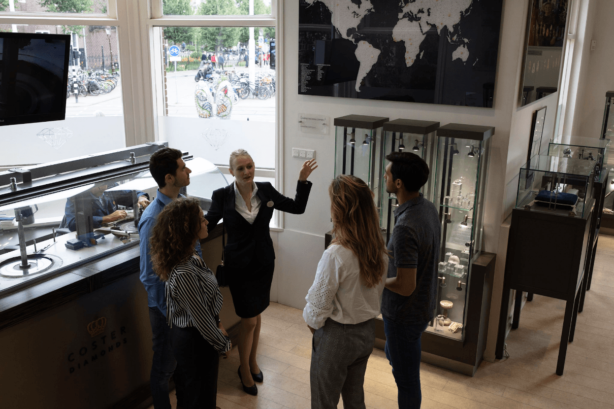 Guided diamond factory tour group inside Royal Coster showroom