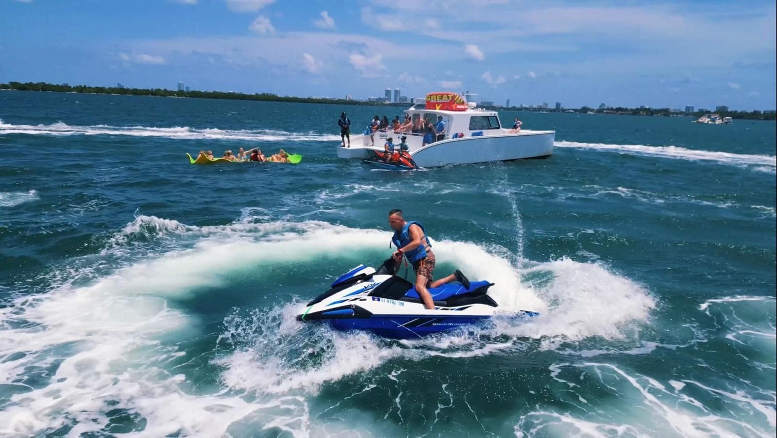 Jet ski rider carving waves off Miami coastline, ocean tour