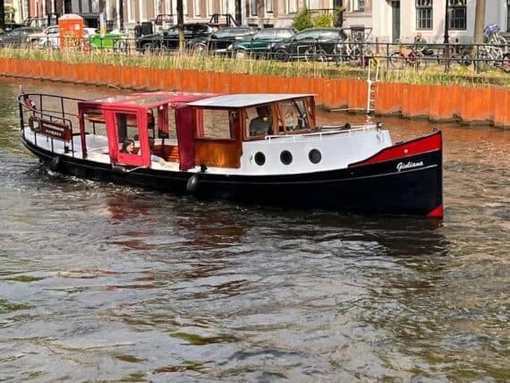 Canal boat cruising calm urban waterways past canal houses