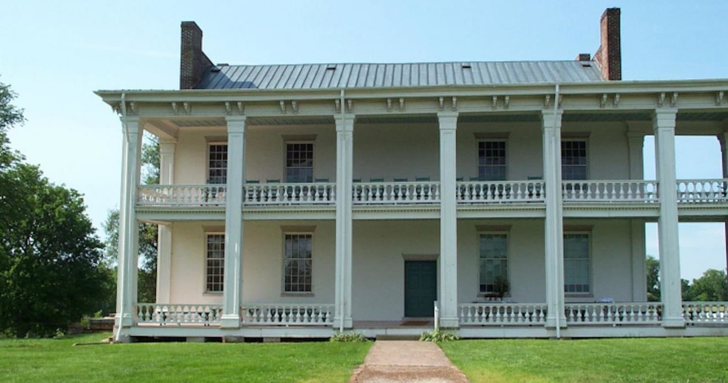 Historic Southern plantation house with wide lawn and porch