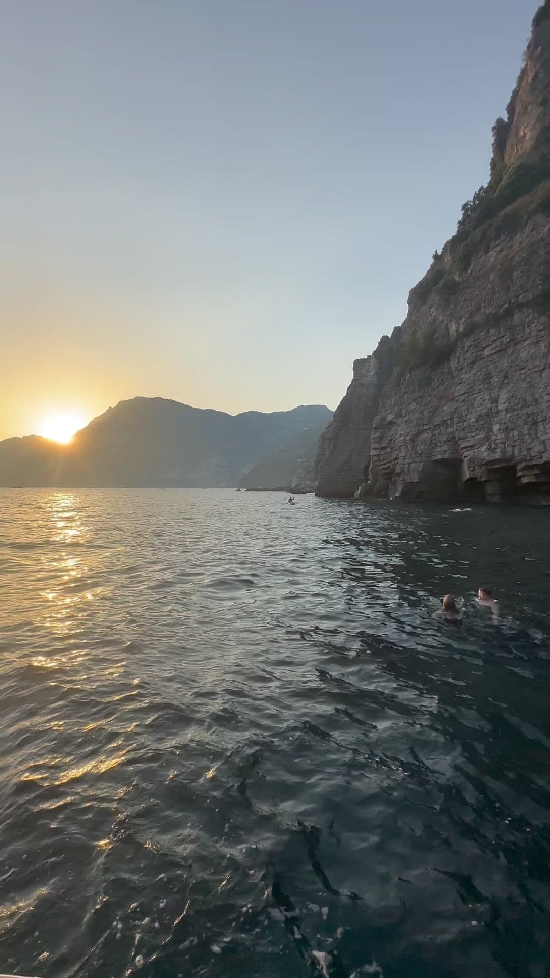 Sunset cliffside sailing near Amalfi Coast, coastal swim spot