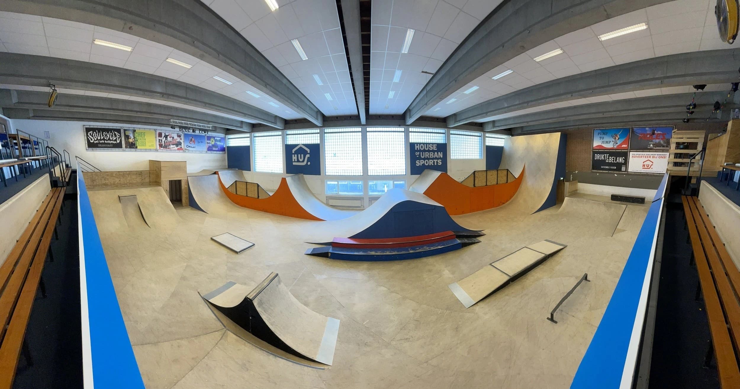Indoor skatepark ramps and bowls in spacious sports hall