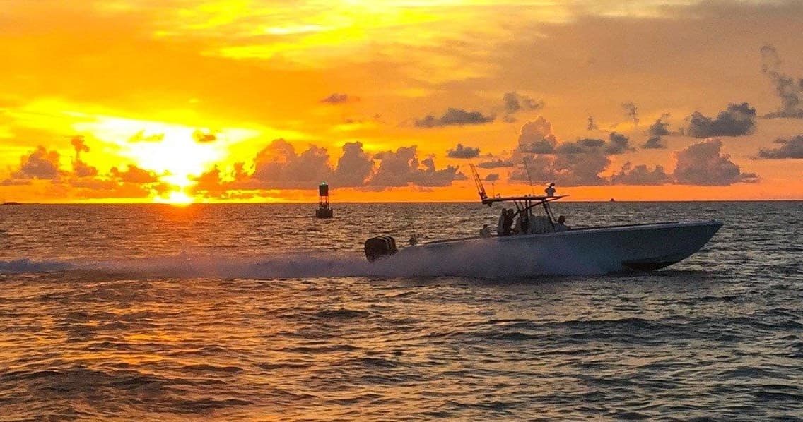 Sportfishing boat silhouetted at sunset off Key West Florida