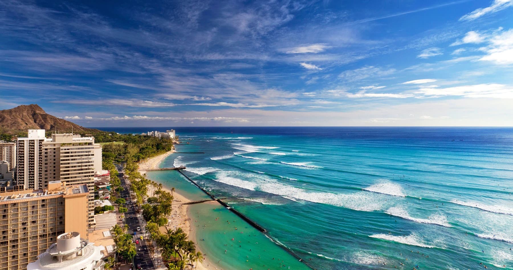 Aerial Waikiki beach coastline with turquoise surf in Oahu