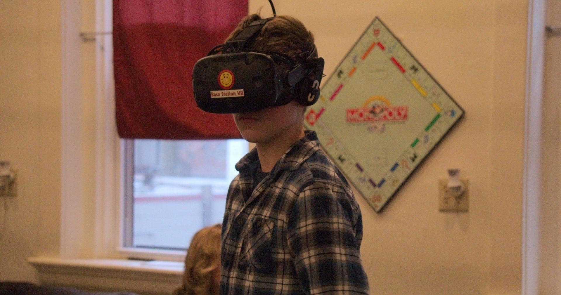 Teen wearing VR headset indoors in demonstration room