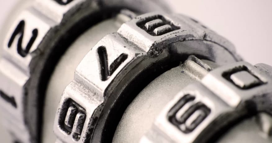 Macro combination lock close-up suggesting puzzle challenge, metallic detail