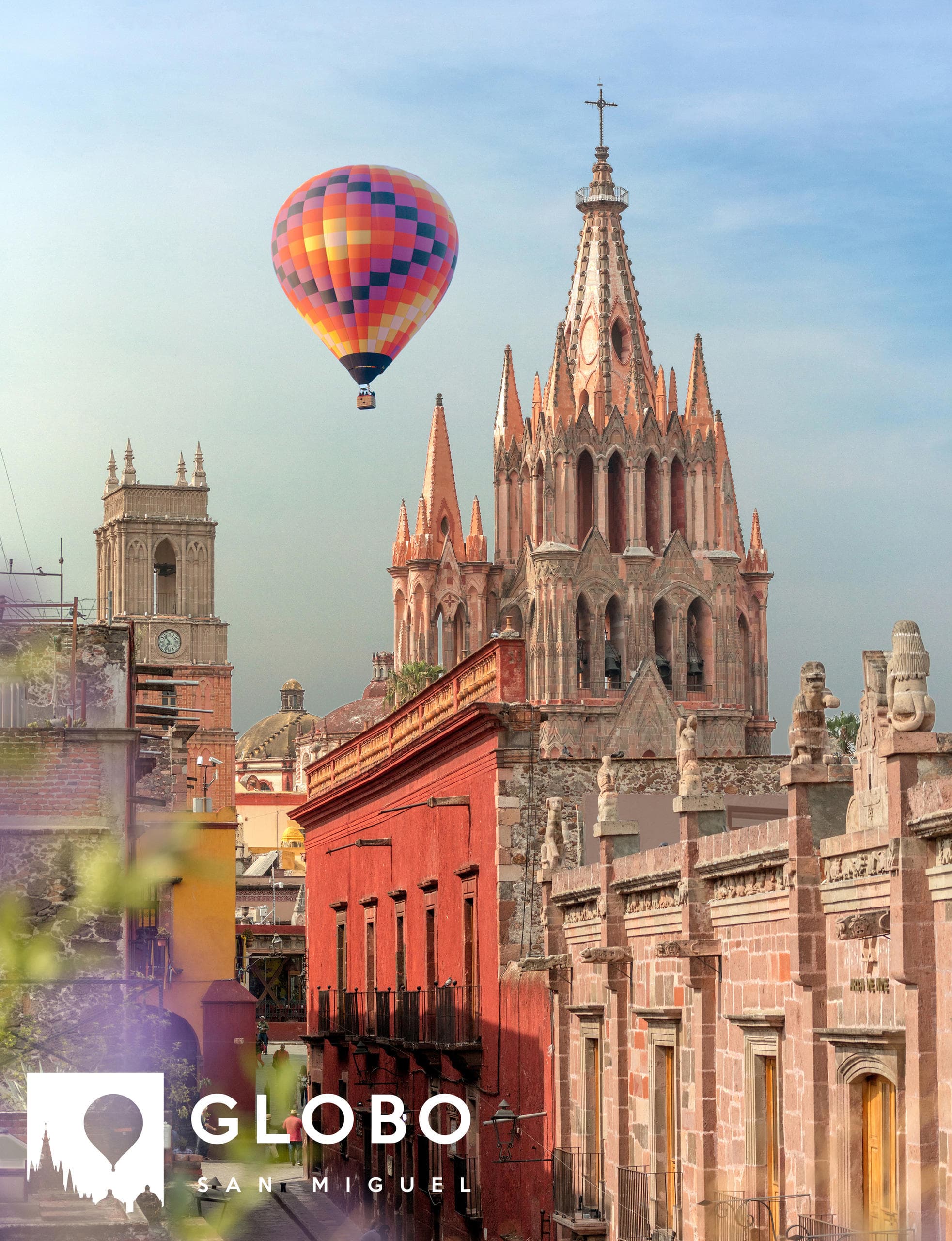 Hot air balloon over San Miguel de Allende city skyline at sunrise