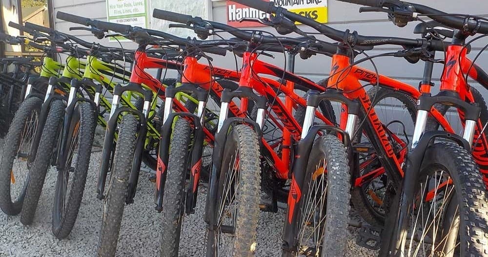 Line of rental mountain bikes parked outdoors ready to ride