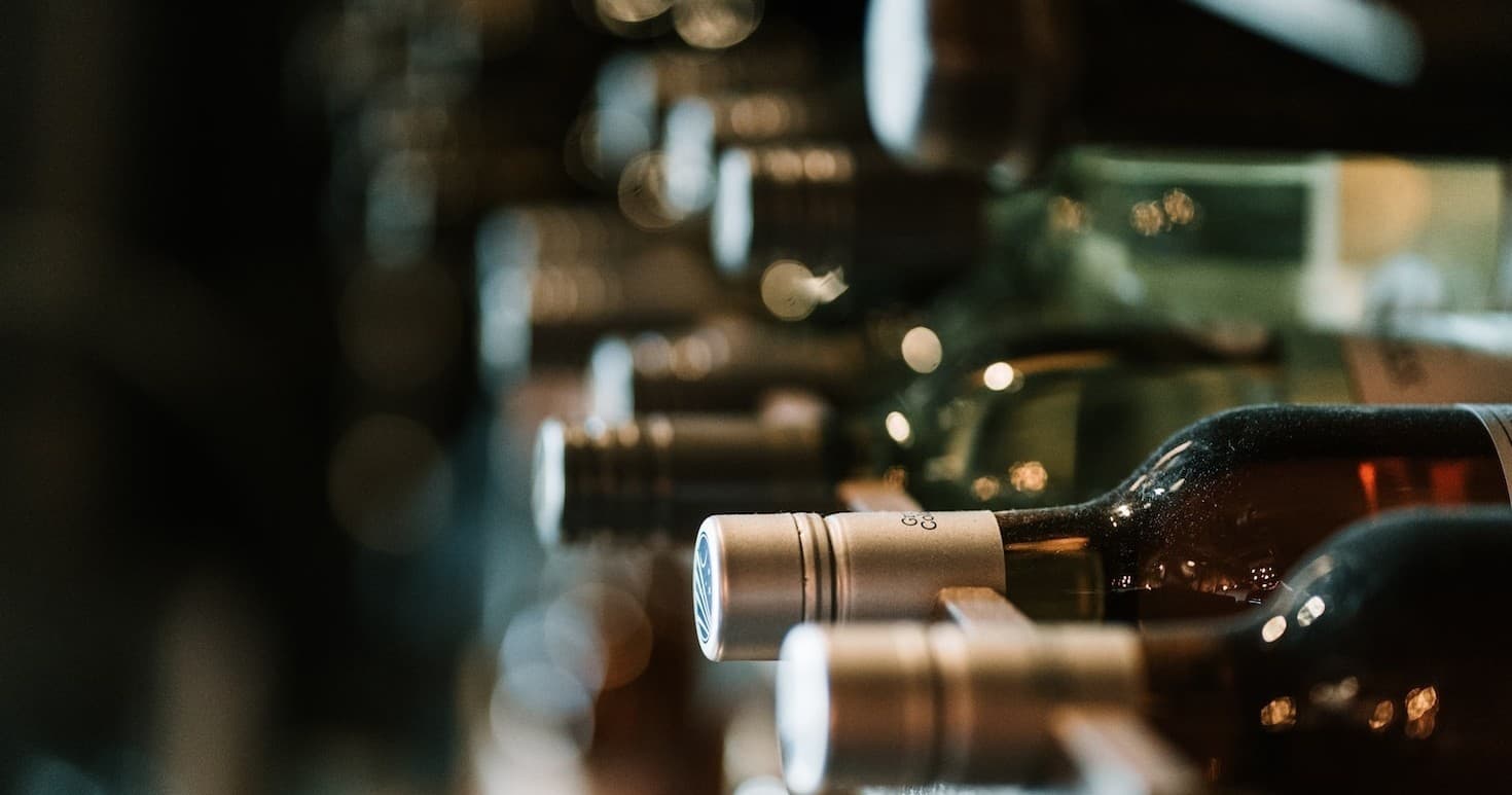 Bottles stored in wine cellar racks for tasting tour