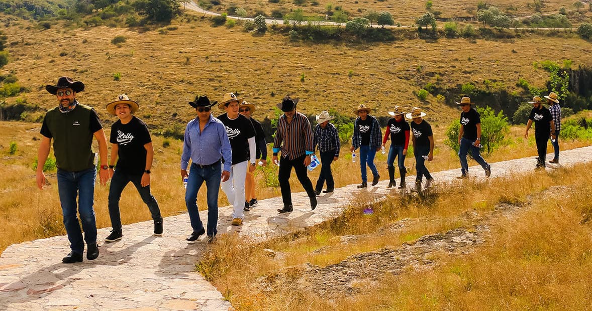 Guided trail hike with group on sunlit rural dirt path