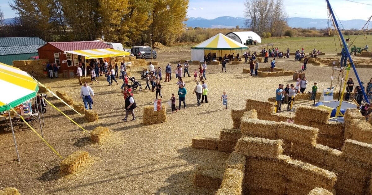 Outdoor hay maze and fall festival grounds with tents in Bozeman