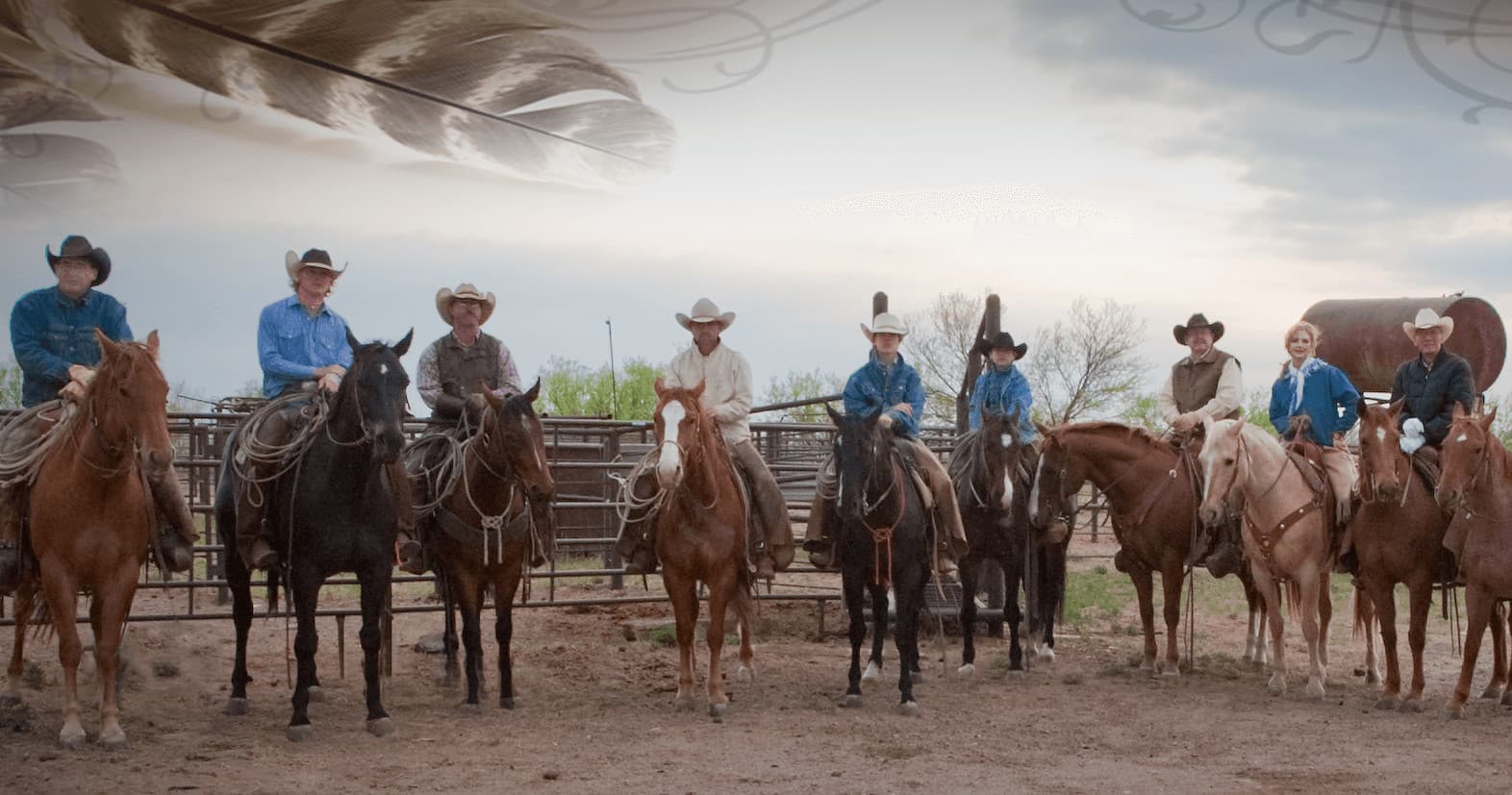 Group of cowgirls and cowboys mounted on horses at ranch