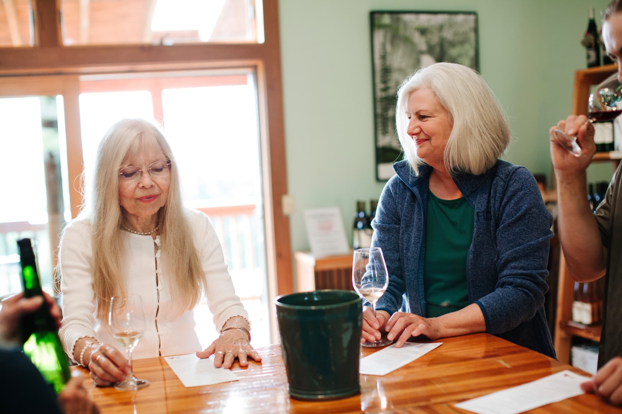 Wine tasting indoors with guests sampling pours at bar