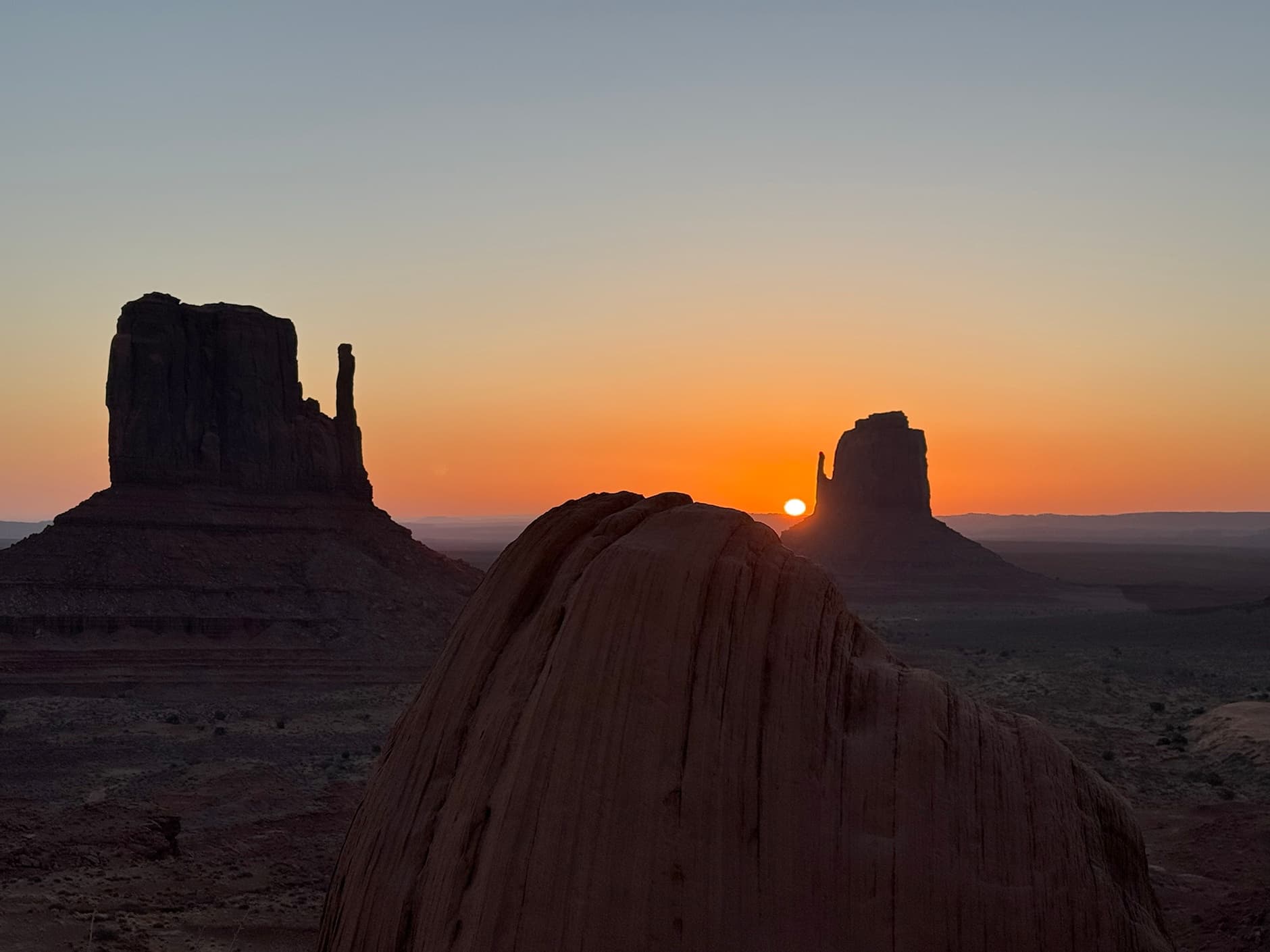 Sunset silhouettes of Monument Valley buttes for scenic tour