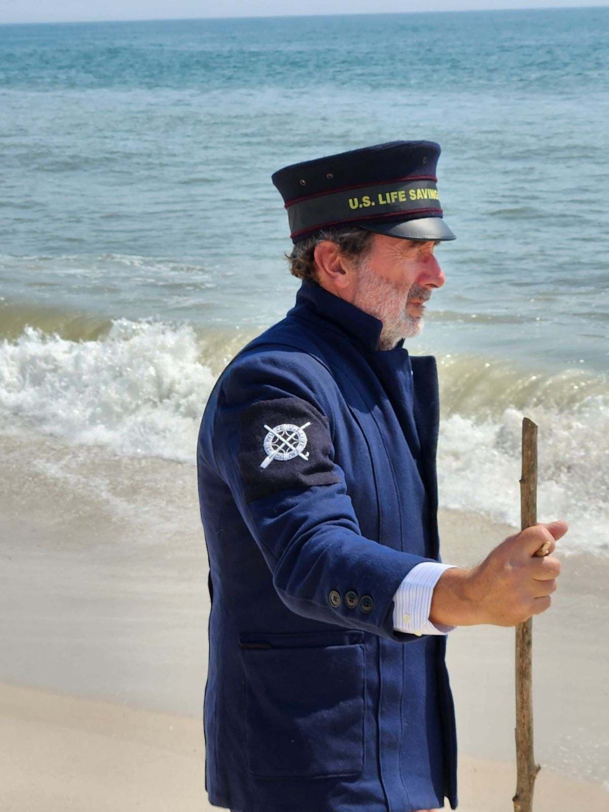 U.S. Lifesaving Service reenactor walking Lewes beach