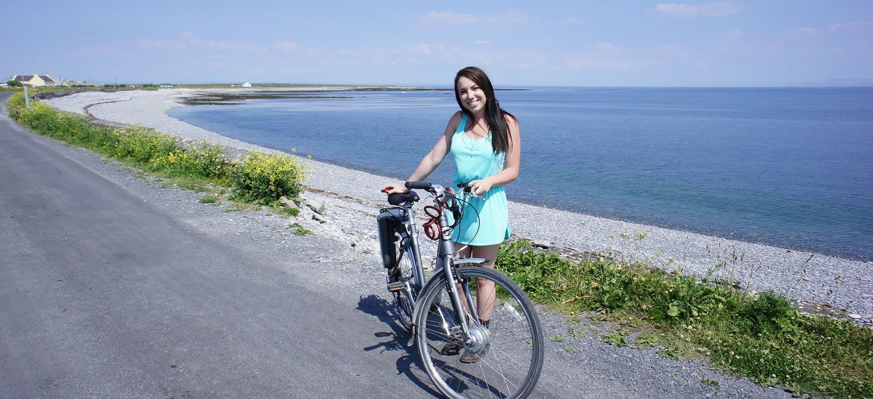 Solo cyclist posing with bike along Aran Islands coastal trail