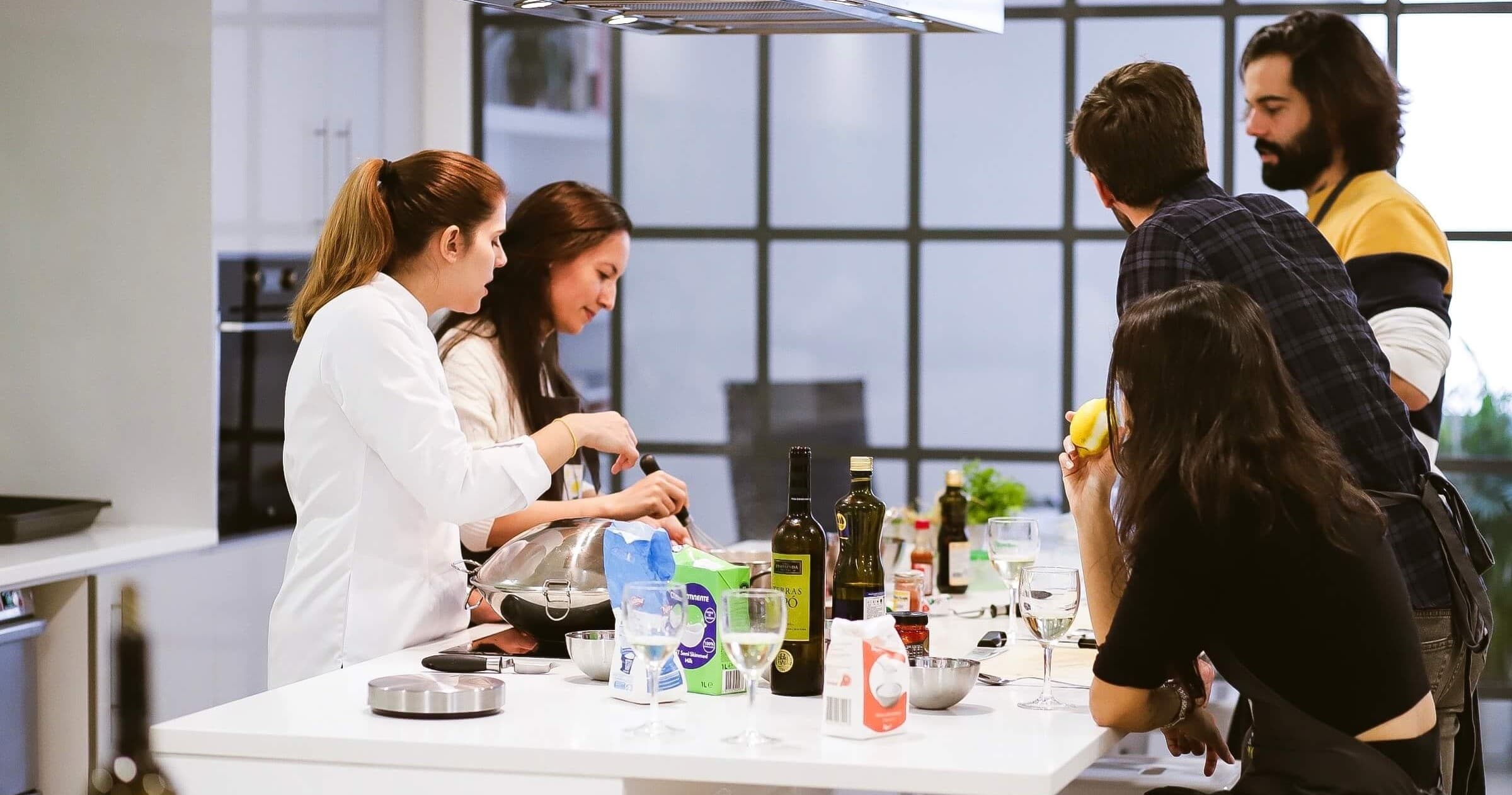 Group hands-on cooking class in Lisbon kitchen, learning skills