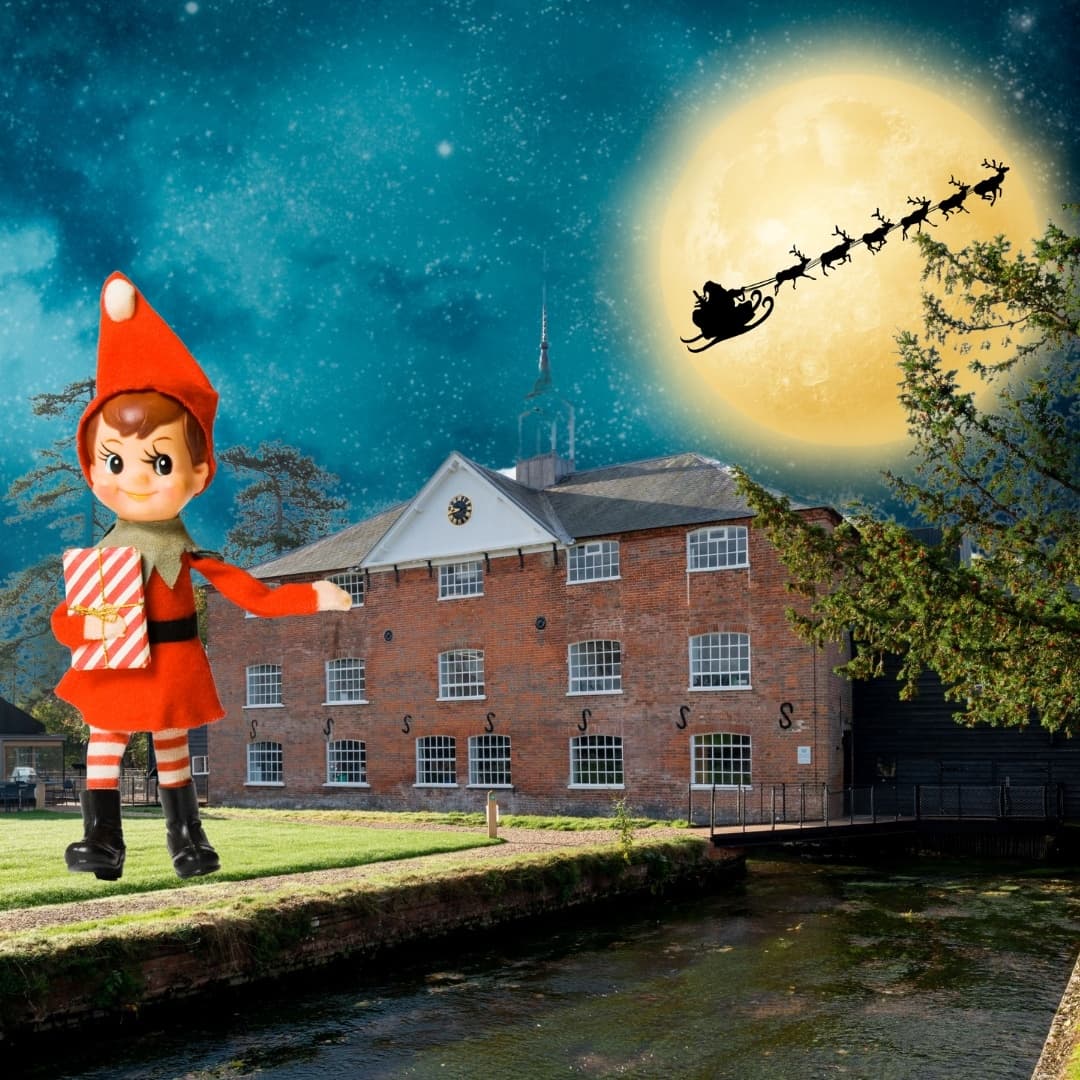 Historic mill riverside at night with festive moon overlay