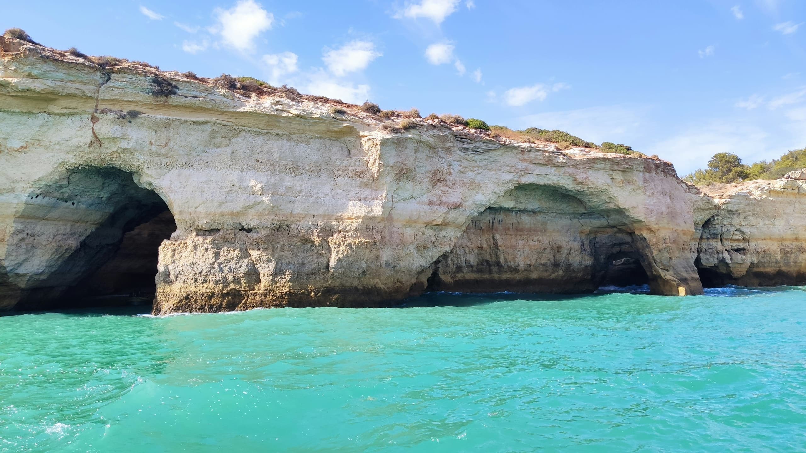 Turquoise waters and coastal caves along Algarve cliffs, Portugal