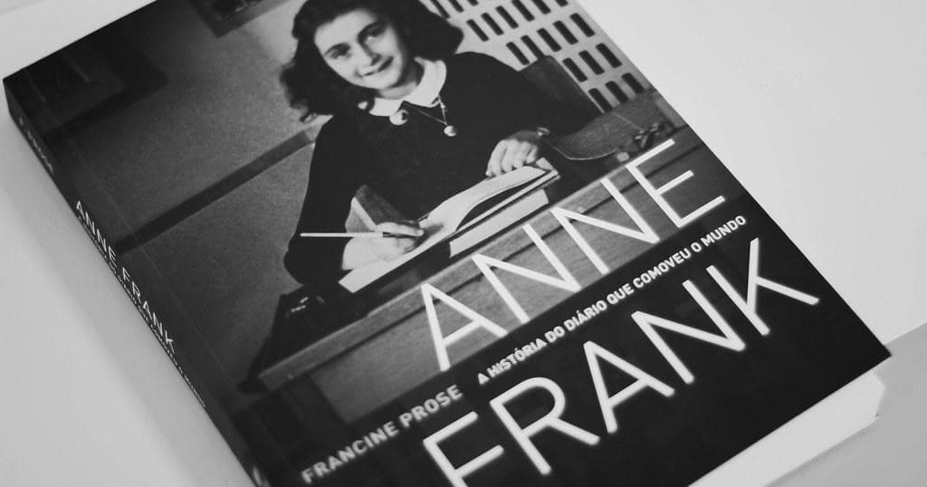 Anne Frank diary book cover black-and-white photo on table