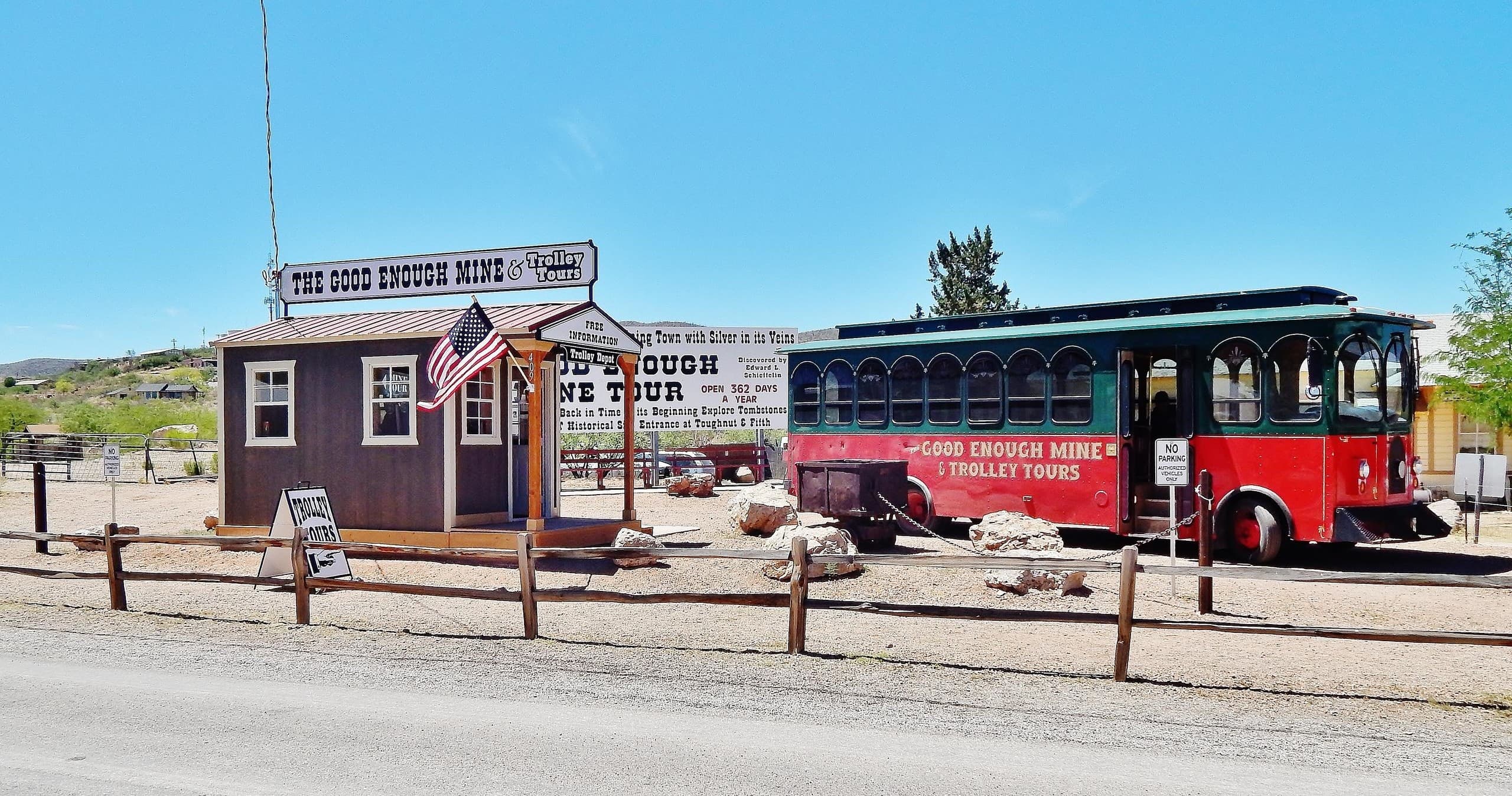 Historic trolley at mine visitor center under blue sky