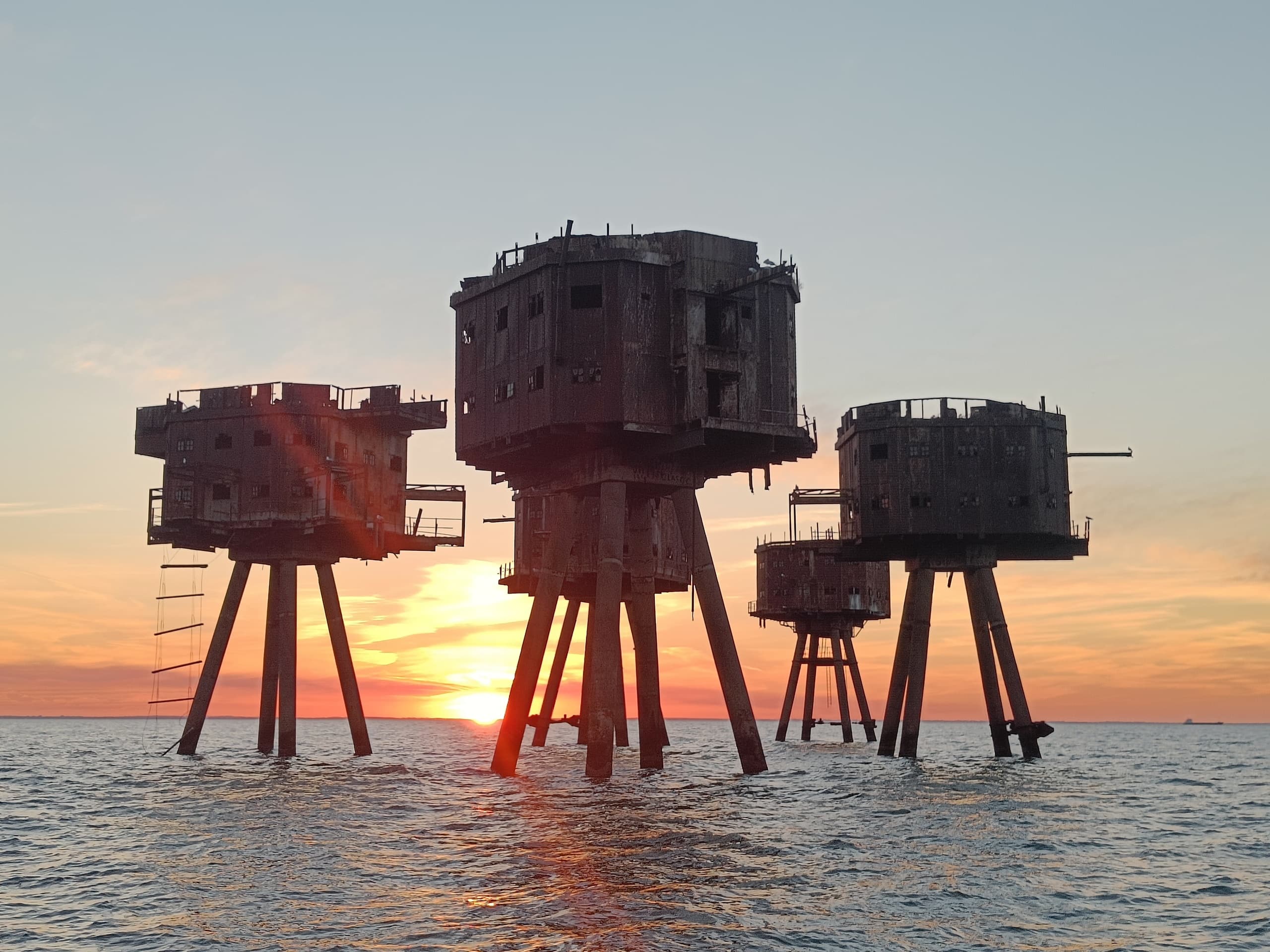 Historic sea forts on stilts at sunset, offshore estuary tour