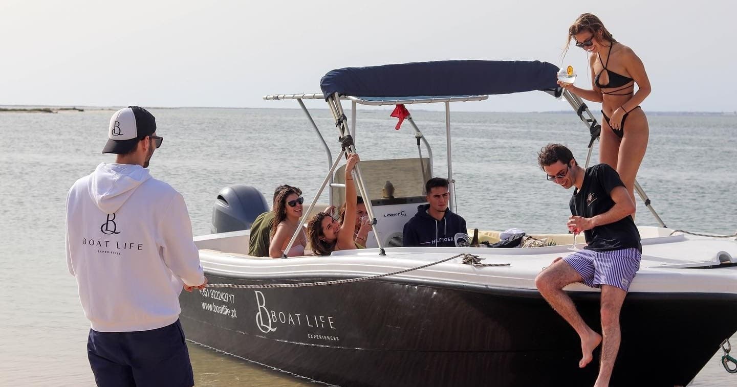 Guests boarding private charter boat on shallow coastal beach