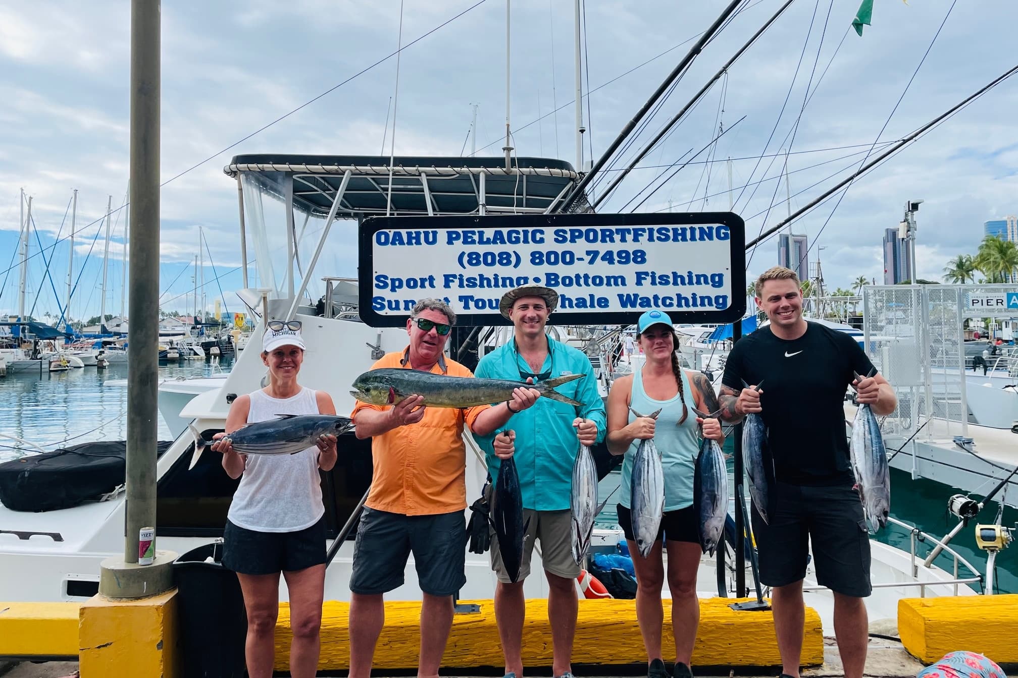 Group of anglers posing with reef fish at Oahu sportfishing dock