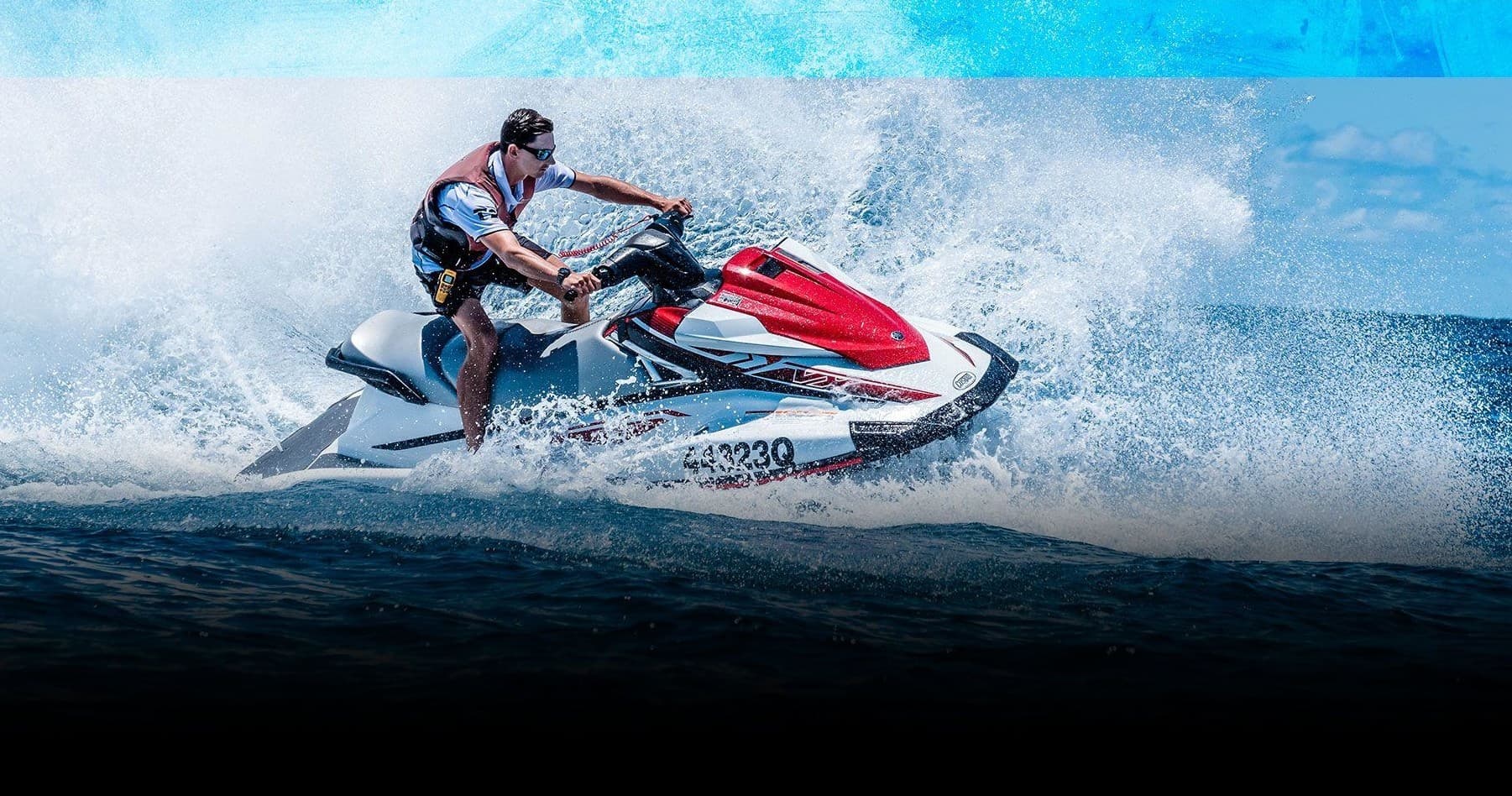 Rider performing high-speed jetski run across ocean spray