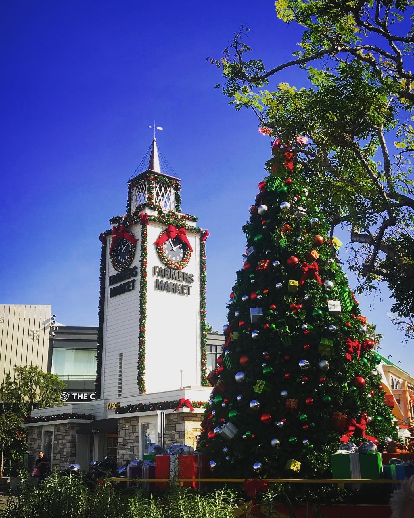 Festive city tower and Christmas tree in urban plaza, holiday scene