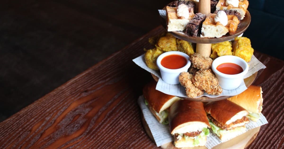Tiered sandwich and dipping sauces platter at cozy gastropub