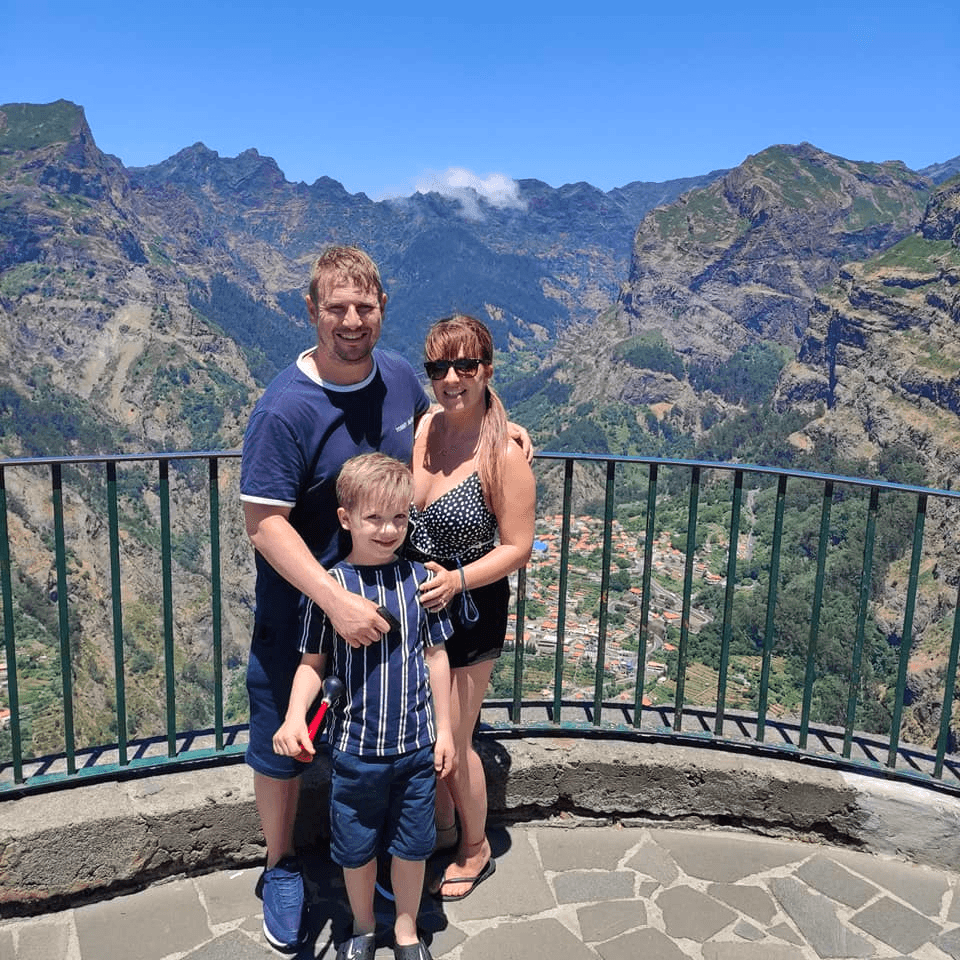 Family at mountain lookout over volcanic valleys, scenic stop
