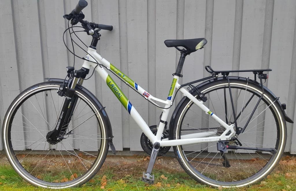 City touring bicycle with rear rack parked outdoors in Lærdal